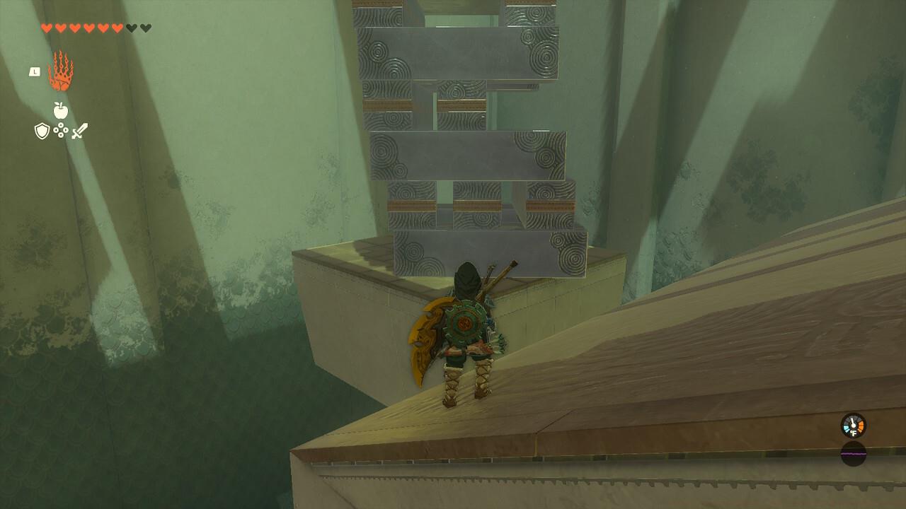 After removing the bottom two blocks, grab the front most bottom piece and push it away from you, causing the ball to fall towards you.