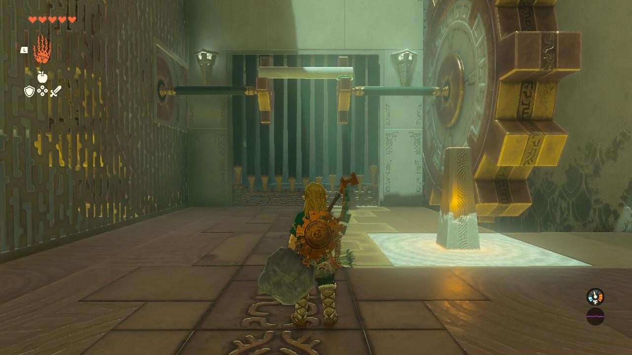 Attach the plank to the gears and then strike the small statue with your weapon to open the gate.