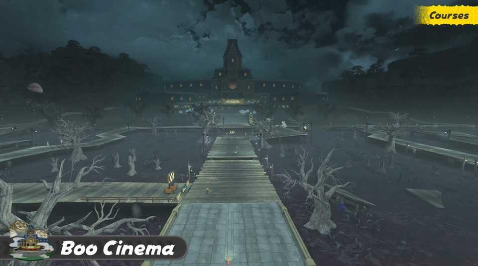 An image of Boo Cinema in Mario Kart World. It shows a stormy sky above a darkened haunted drive-in movie theater.