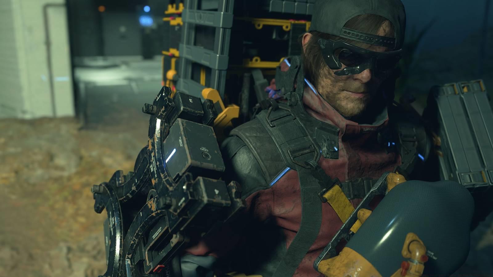 A Death Stranding 2 screenshot showing the protagonist Sam Porter wearing a cap and sunglasses.