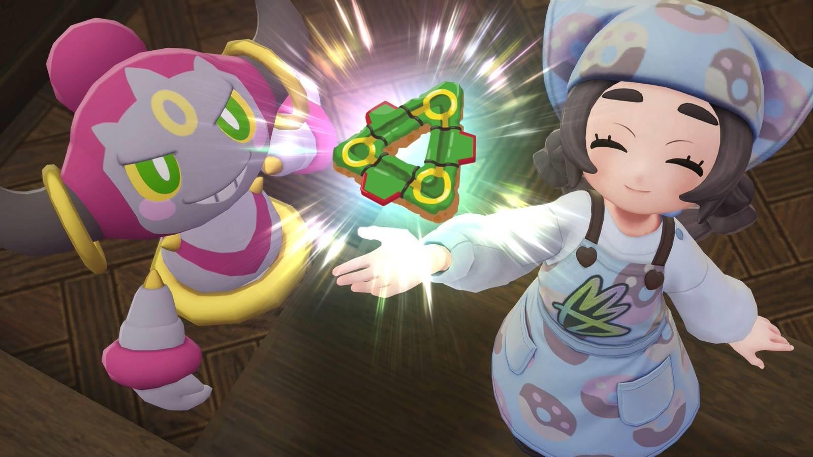 Ansha and Hoopa hold up a Rayquaza triangle donut in Pokémon Legends: Z-A